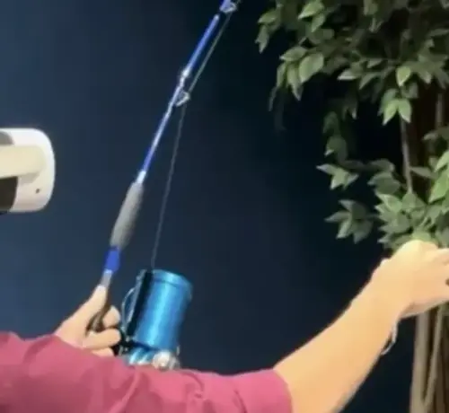 Close view of hands holding the blue rod and its reel