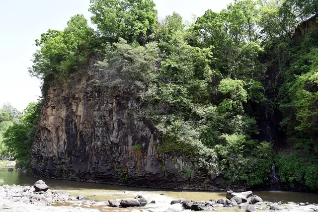 Columnar basalt cliffs above the water on a branch of the Hantan River