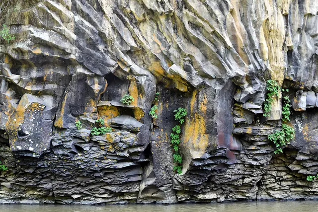 Columnar basalt cliffs above the water on a branch of the Hantan River